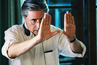 A film director frames a shot between his hands.