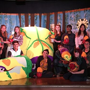Technical crew members on the stage of Little Shop of Horrors.