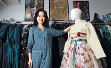 a costume designer stands with a mannequin wearing her work
